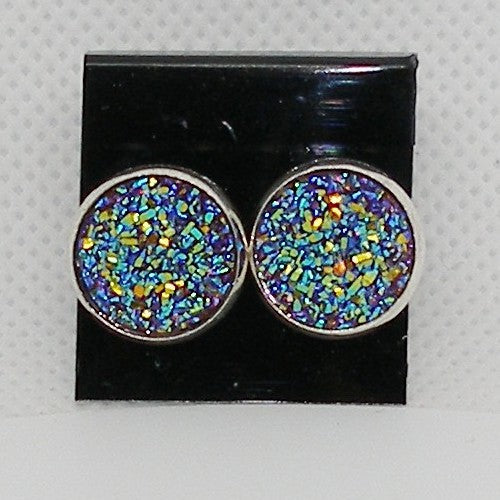 Multicolored glittery round earrings on a black card with a gray background