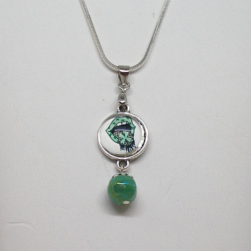 Necklace with a green pendant and silver chain on a white background