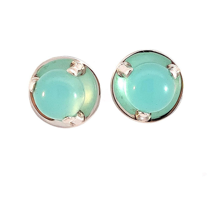 photo of silver earrings set with a blue chalcedony cabachon on a white background