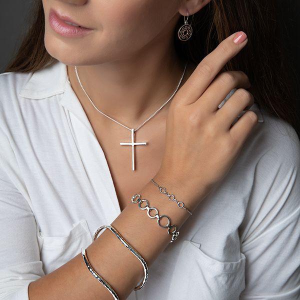 photo of a brunette model wearing a silver and black circle drop style earring