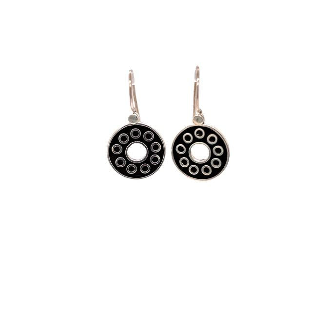 photo of a silver and black circle drop style earring on a white background
