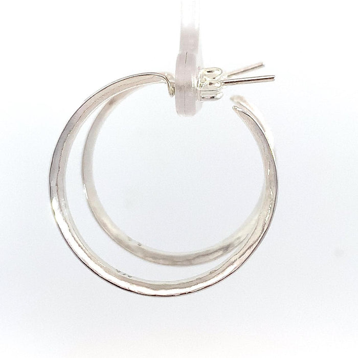 Taxco sterling silver concave hammered hoop earrings with textured artisan finish and post clutch backing side view