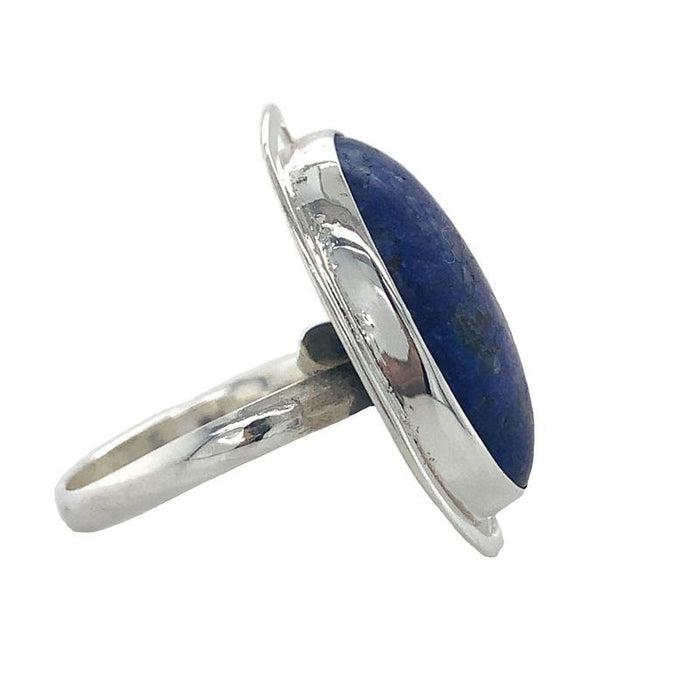 A Sterling Silver Lapis Ring featuring a large oval cabochon Lapis Lazuli set in a fine silver bezel-setting, with a scalloped edge design.