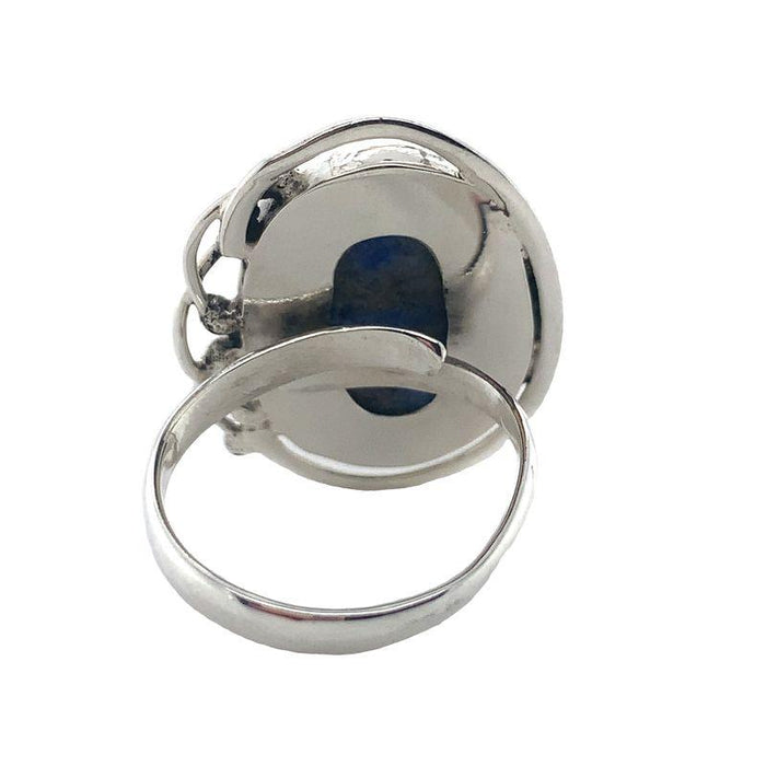 A Sterling Silver Lapis Ring featuring a large oval cabochon Lapis Lazuli set in a fine silver bezel-setting, with a scalloped edge design. rear view