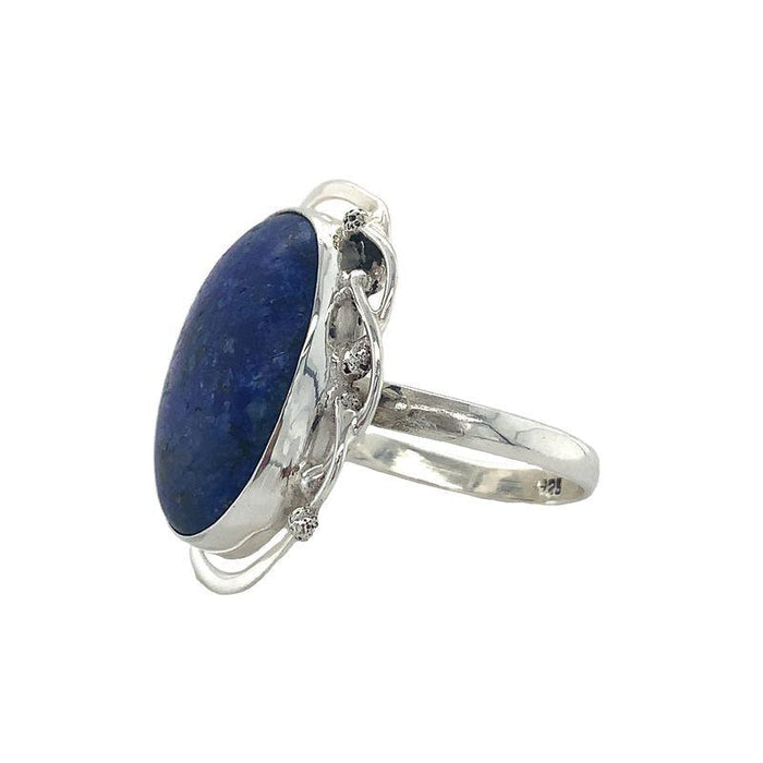 A Sterling Silver Lapis Ring featuring a large oval cabochon Lapis Lazuli set in a fine silver bezel-setting, with a scalloped edge design. side view
