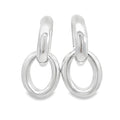 photo of a pair of large silver two-part doorknocker earrings on a white background