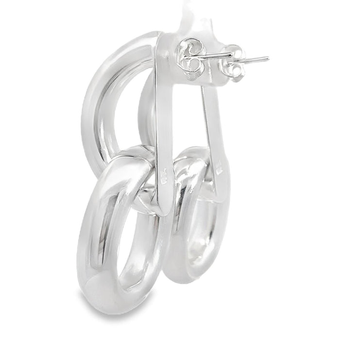 photo of a pair of large silver two-part doorknocker earrings on a white background side view