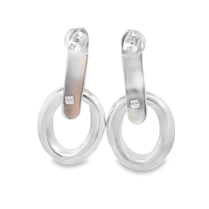 photo of a pair of large silver two-part doorknocker earrings on a white background rear view