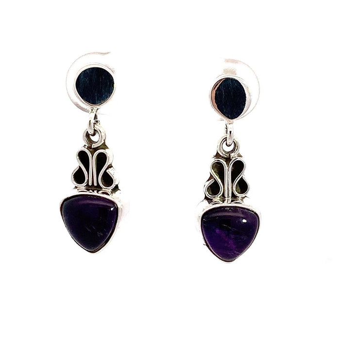 photo of a silver drop earring with a trillion cabochon amethyst bottom on a white background