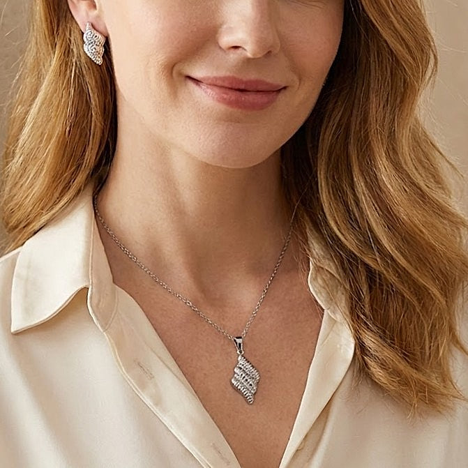 Elevate her jewelry collection with this stunning silver-plated Stirling Ripple Set that blends European classic charm with a modern twist. Symbolizing grace and freedom, this set offers a meaningful gesture with a fade-resistant finish that reflects a lasting bond. The delicate feather design, accented by shimmering thread drills, creates a sophisticated look that transitions perfectly from day to night.