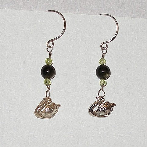 Pair of Swan-shaped earrings with black and green beads on a white background