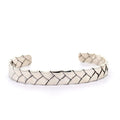 photo of a silver woven cuff on a white background