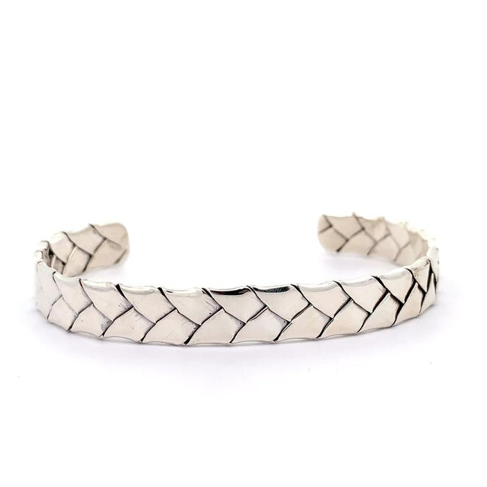 photo of a silver woven cuff on a white background