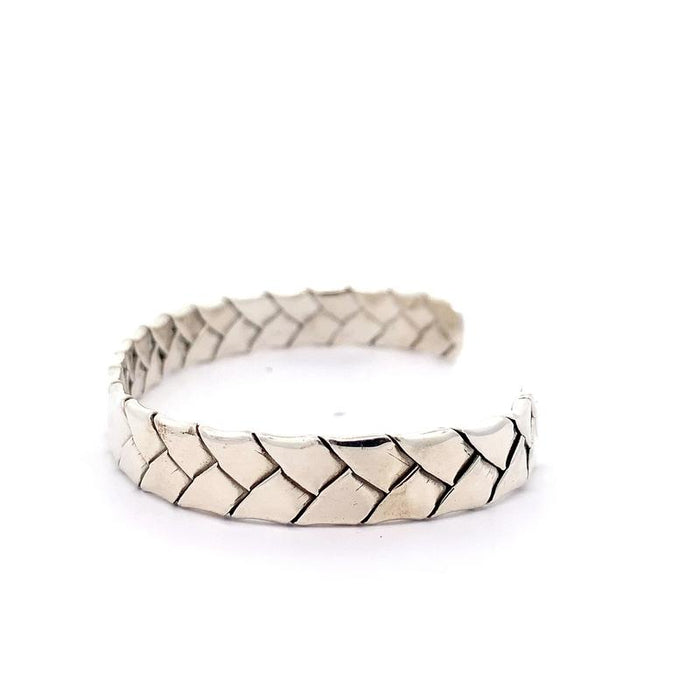 photo of a silver woven cuff on a white background side view