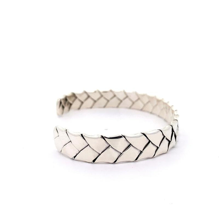 photo of a silver woven cuff on a white background side view