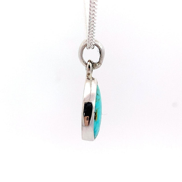 photo of a silver pear shape bezel set turquoise pendant and chain on a white background side view