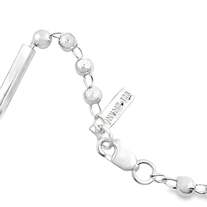 photo of a zoomed in section of a silver ball and bar link chain on a white background