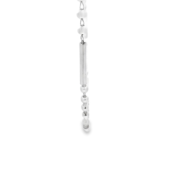 photo of a zoomed in section of a silver ball and bar link chain on a white background
