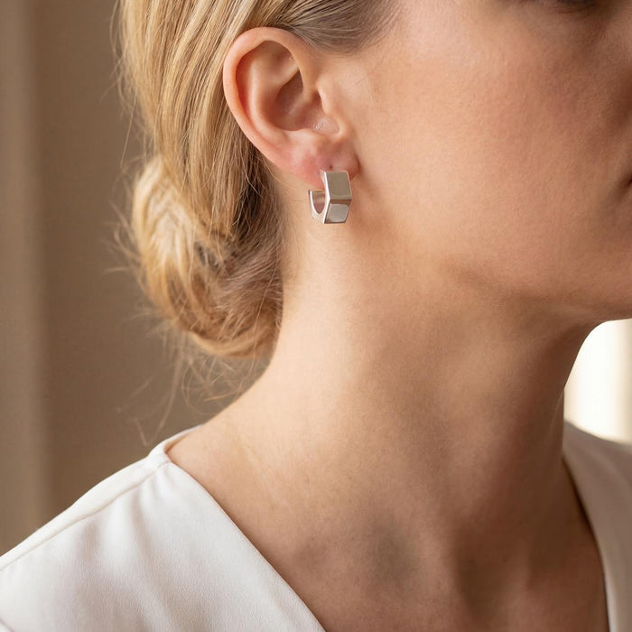 blond model wearing a Taxco artisan sterling silver geometric hoop earring bright polish finish 15mm diameter handcrafted Mexican silver jewelry