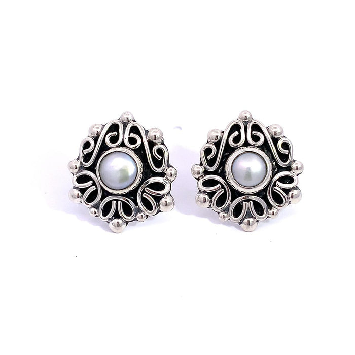 Taxco artisan sterling silver pearl stud earrings bezel set pearl with raised scrollwork frame handcrafted Mexican silver jewelry