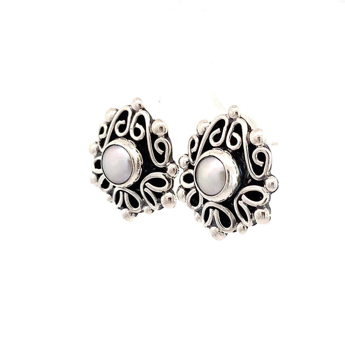 Taxco artisan sterling silver pearl stud earrings bezel set pearl with raised scrollwork frame handcrafted Mexican silver jewelry