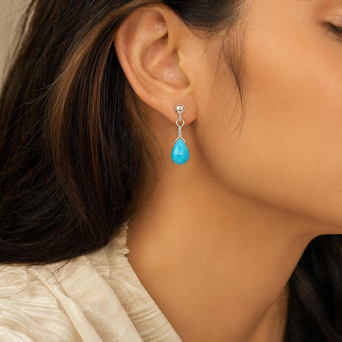 brunette model wearing a Sterling silver turquoise briolette dangle earring handmade in Taxco Mexico