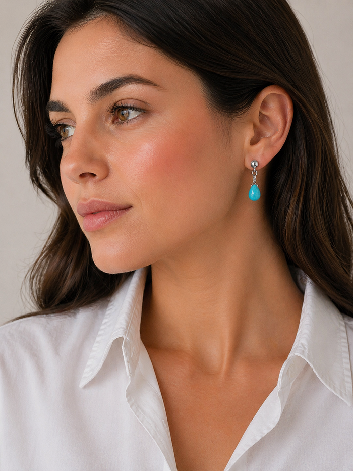 brunette model wearing a Sterling silver turquoise briolette dangle earring handmade in Taxco Mexico
