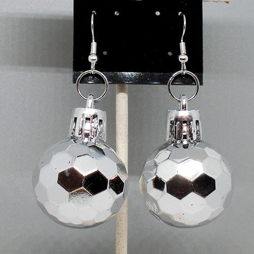 Silver faceted ball earrings on a gray background