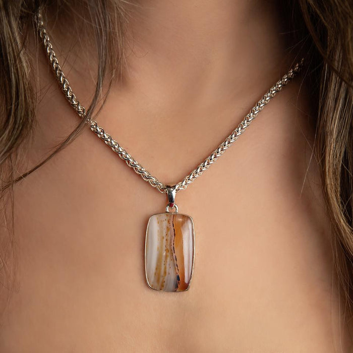 photo of a brunette model wearing an agate silver pendant on a silver chain