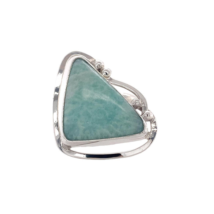 photo of a silver ring set with a triangular light blue opaque gem on a white background