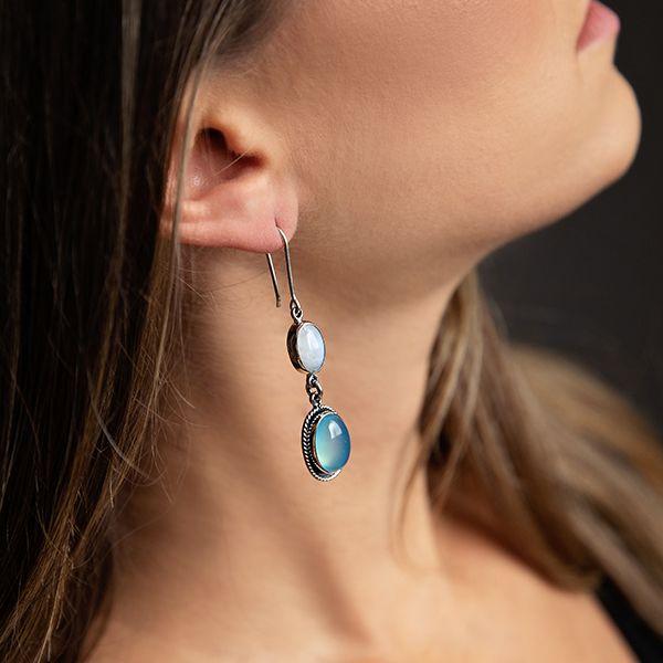 photo of a brunette model wearing a 2-part dangle silver earring with oval moonstone and oval blue chalcedony