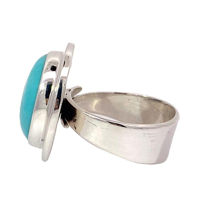 photo of a silver round cabochon Turquoise ring on a white background side  view