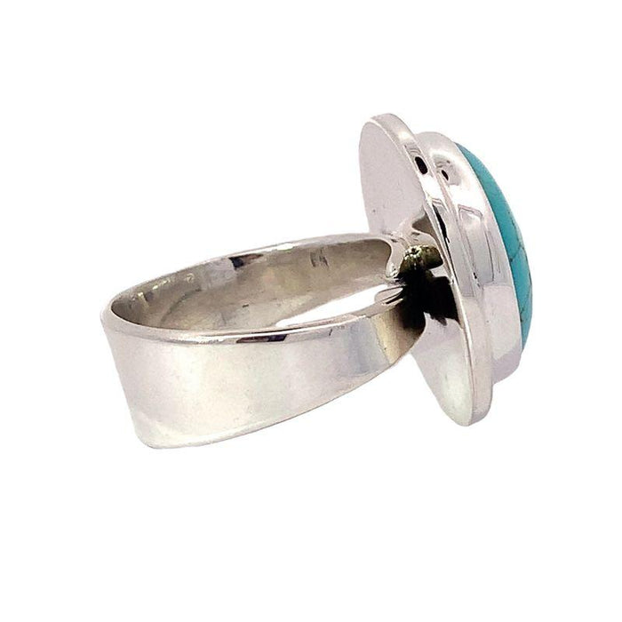 photo of a silver round cabochon Turquoise ring on a white background side  view
