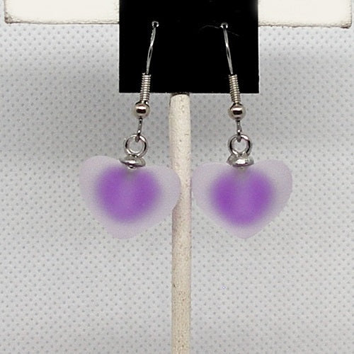 Heart-shaped earrings with purple centers on a white background