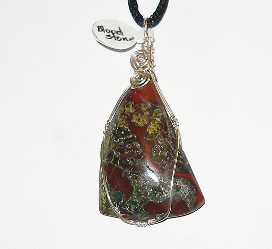 Jasper pendant necklace with wire wrap on a white background