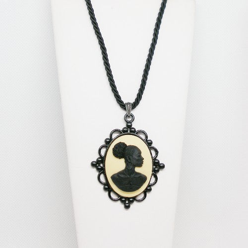 Necklace with a cameo pendant featuring a silhouette on a white background