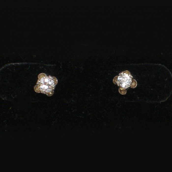 Pair of white zircon stud earrings on a black background